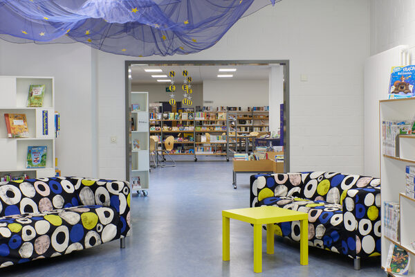 A seating area in the library in front of several bookshelves.