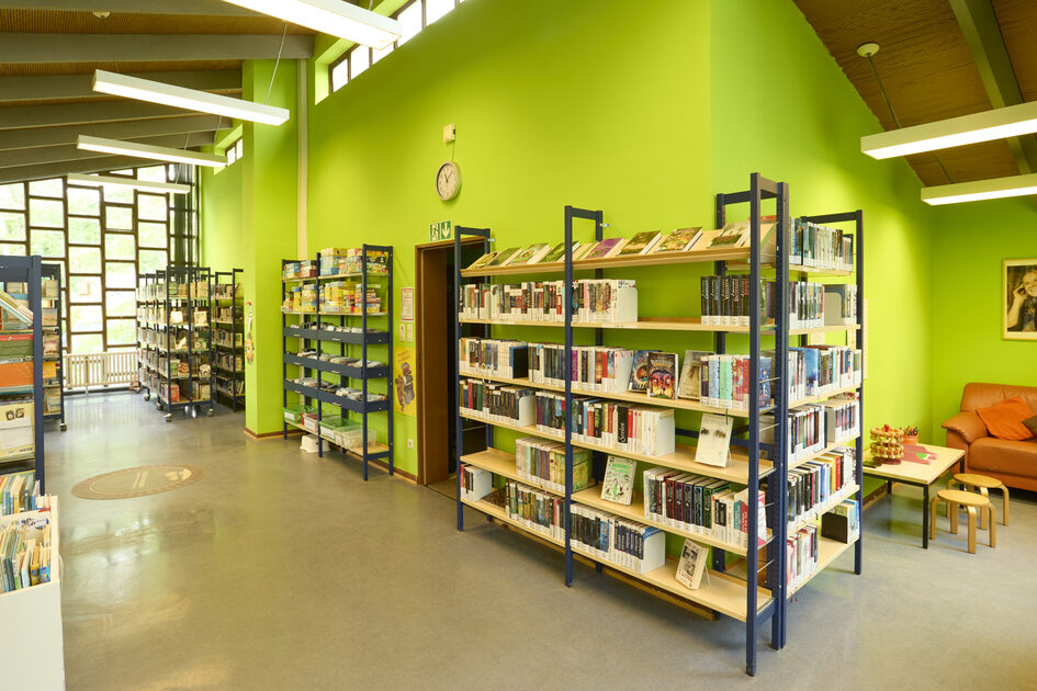 Several bookshelves line the walls of the district library.