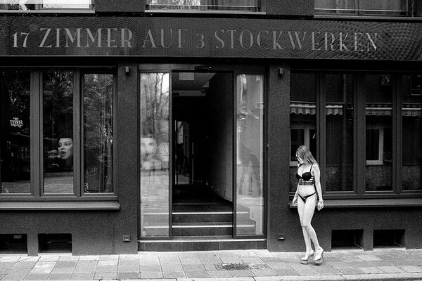 A prostitute in front of the brothel