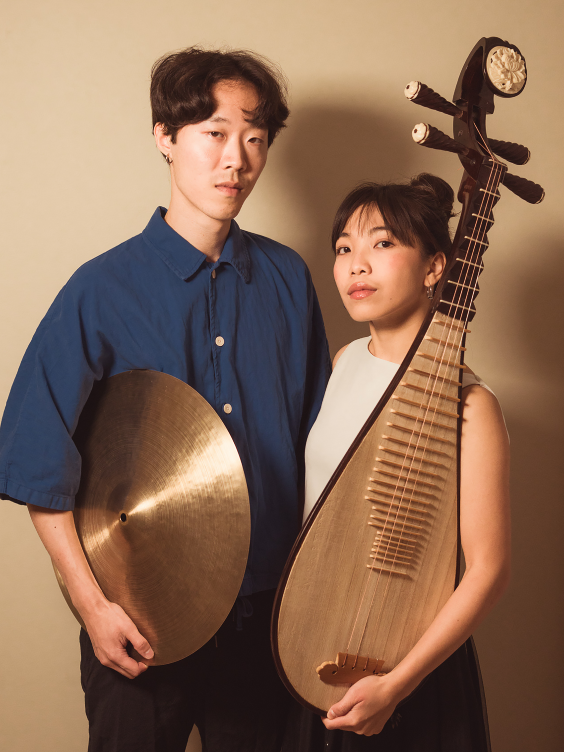 Asian woman and Asian man with musical instruments