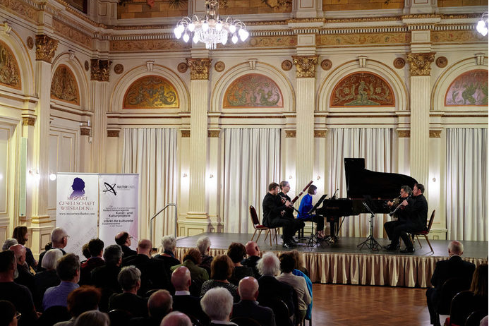 Musicians on stage in a festive hall