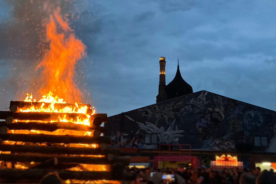 Large bonfire in front of the event hall.