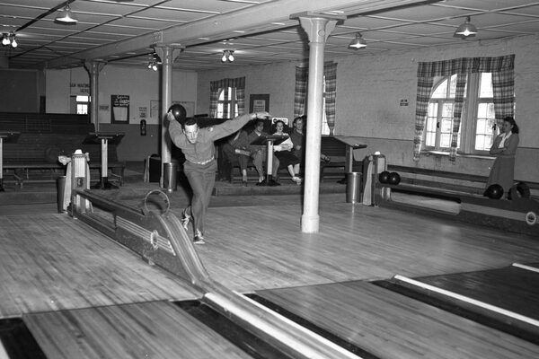 A man plays bowling at a bowling alley at Lindsey Air Station.