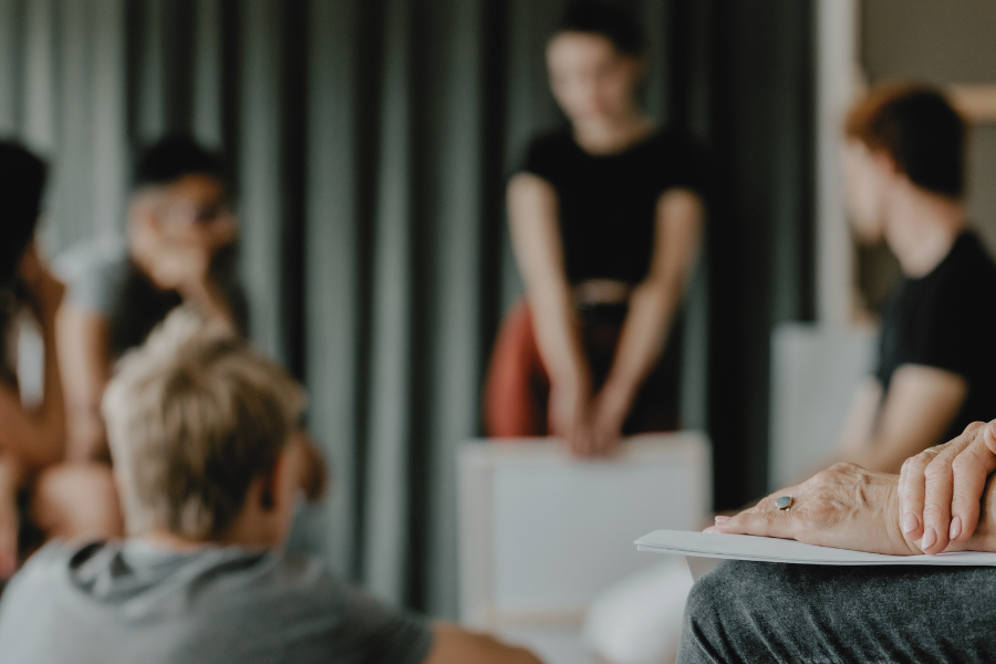 Няколко души разговарят. Те седят един срещу друг.