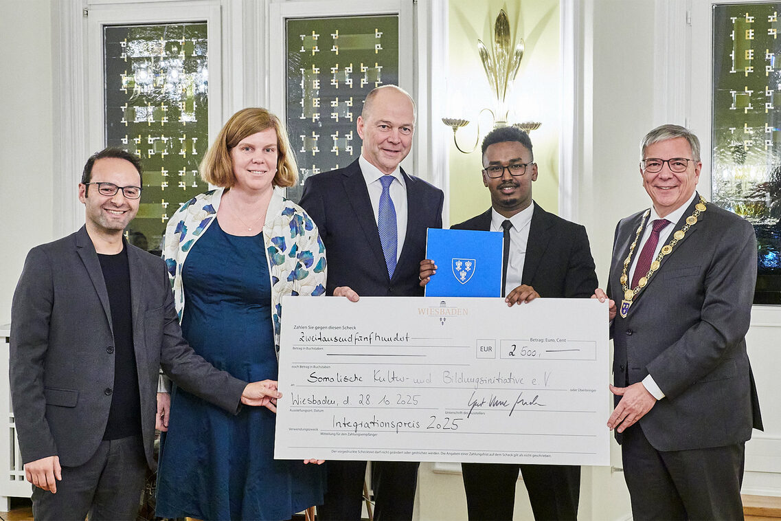 Ödül töreninde çekle birlikte 2025 kazanan: bir kadın ve dört erkek.