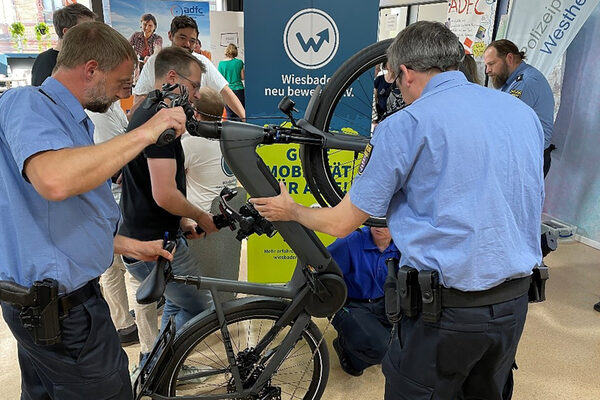Two police officers check an e-bike.