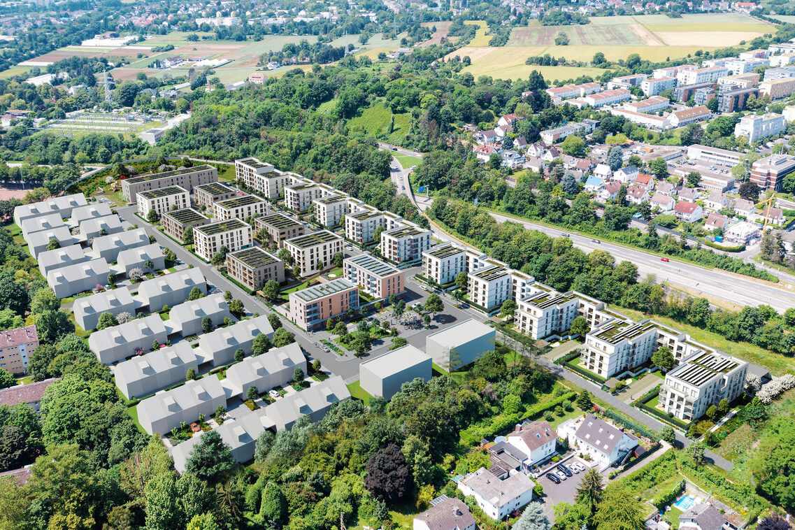 Eine Modellansicht des neuen Wohngebiets Kärntner-Viertel aus der Vogelperspektive zeigt in Richtung des Siedlungsbestandes kleinteilige Bebauung, gefolgt von vier- bis fünfgeschossigen Mehrfamilienbauten in lockerer Anordnung, die einen Lärmschutz in Richtung der Autobahn gewährleisten und sich um einen zentralen Quartiersplatz gruppieren.