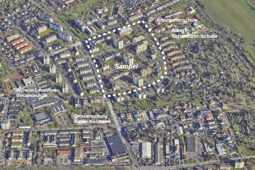 Въздушна снимка на Сампел, на която е очертан районът на проекта и са отбелязани съседните училища и местната администрация.