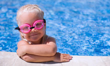 Mädchen im Schwimmbecken mit rosa Taucherbrille