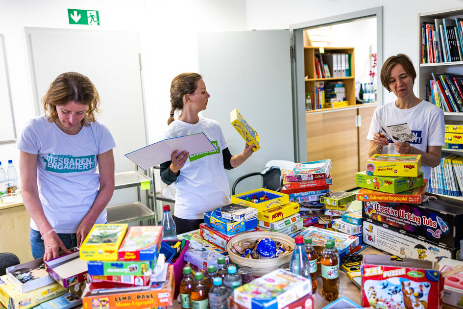 Drei Frauen sortieren Spiele.
