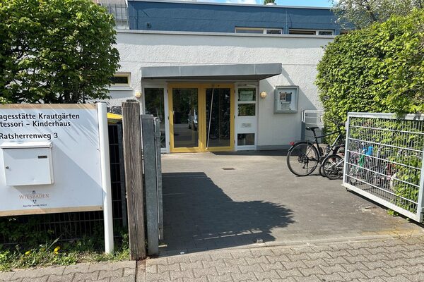 The entrance to the daycare center - on the left is a sign with the name