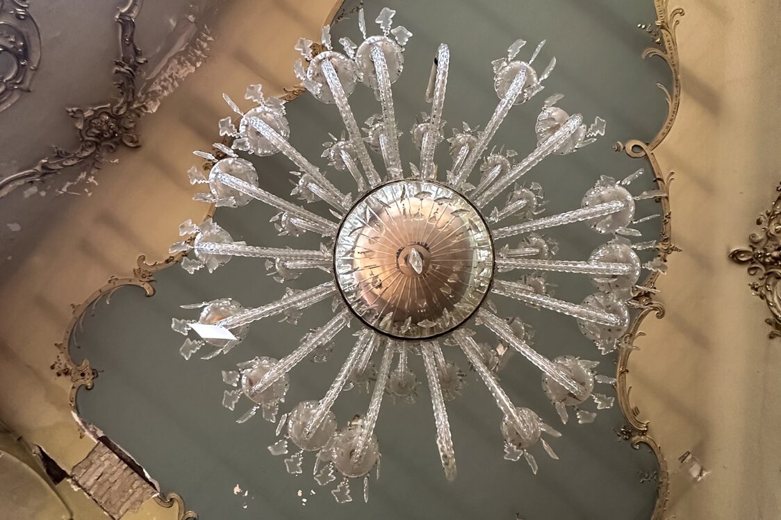 Chandelier and blue-grey stucco ceiling