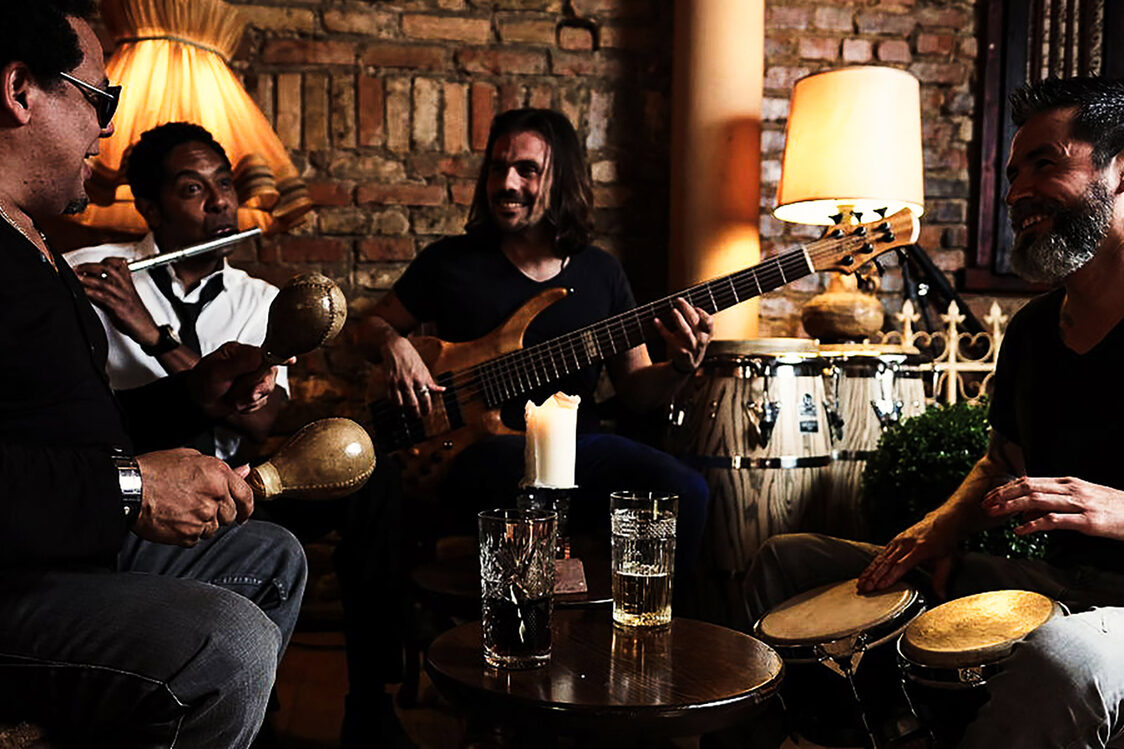 Four musicians with their instruments in action.