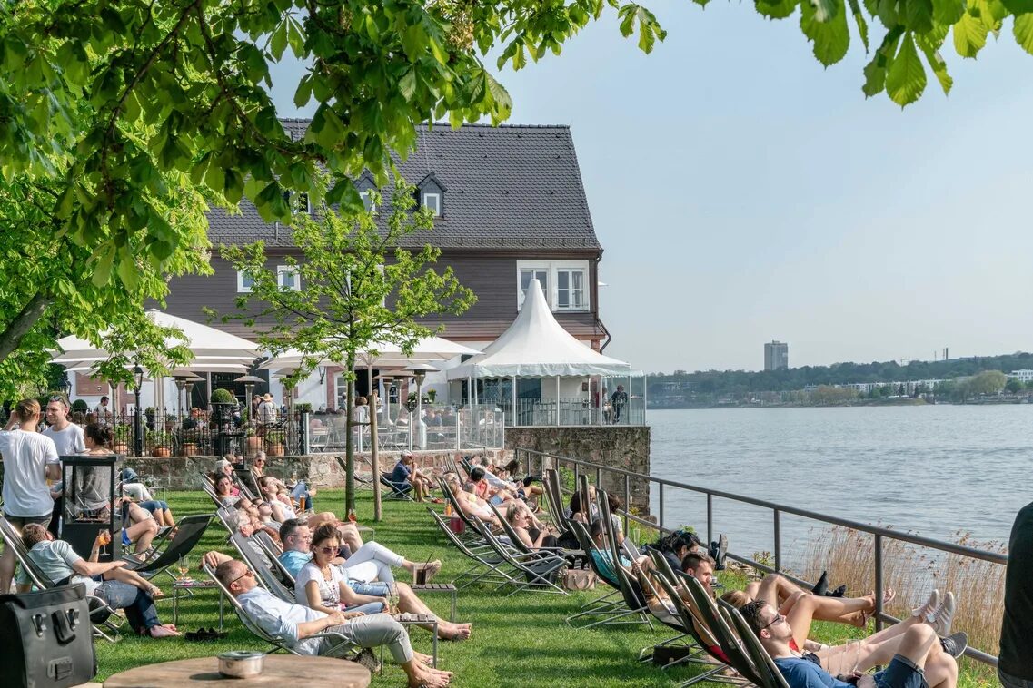 People in deckchairs by the water