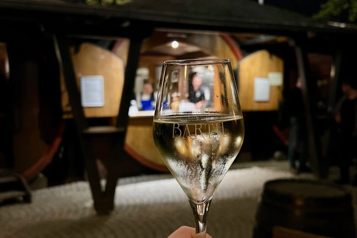 Champagne glass in front of wine barrel