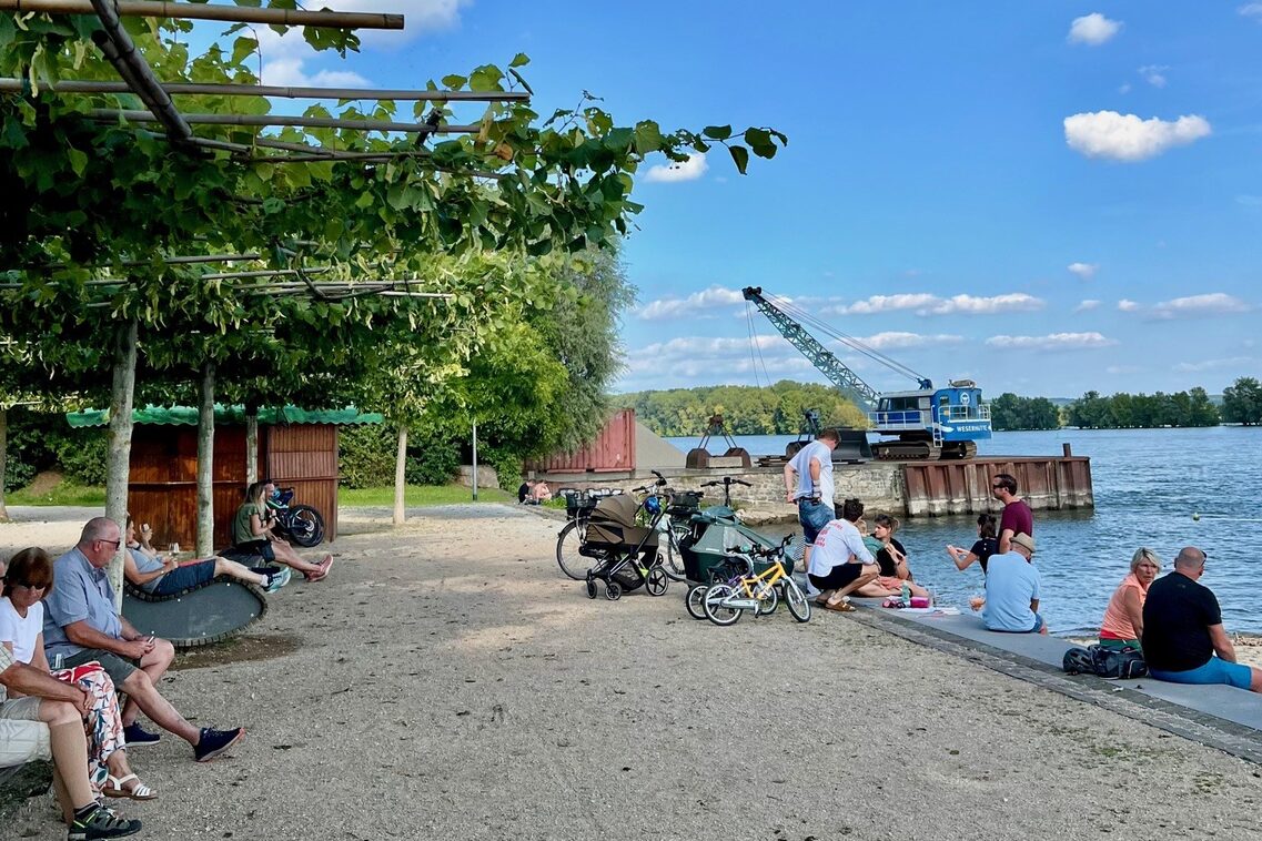 People on the banks of the Rhine with bicycles