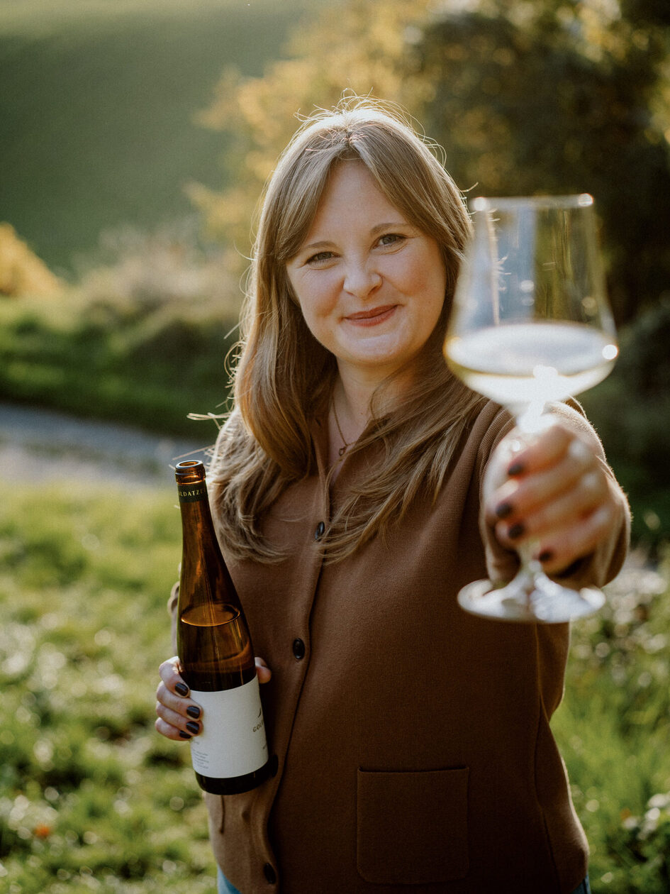 Vivienne Matz with wine glass in the fall light