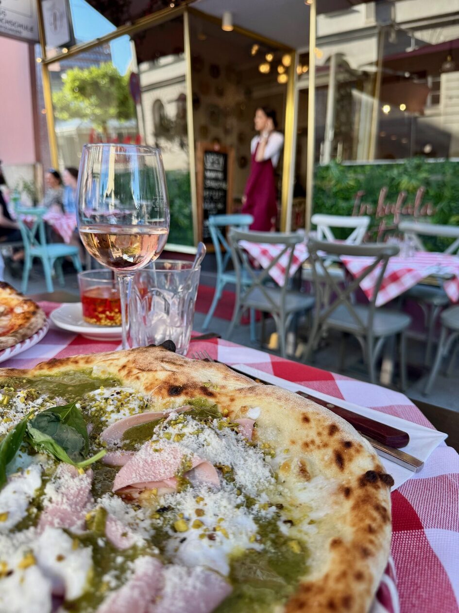 Pizza on a red and white tablecloth
