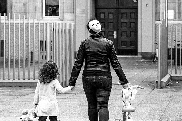 Eine Prostituierte mit Maske auf dem Weg nach Hause mit ihrem Kind