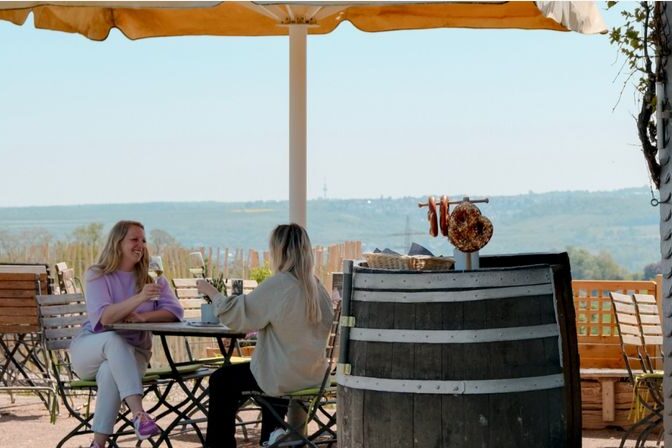 Two women toast each other