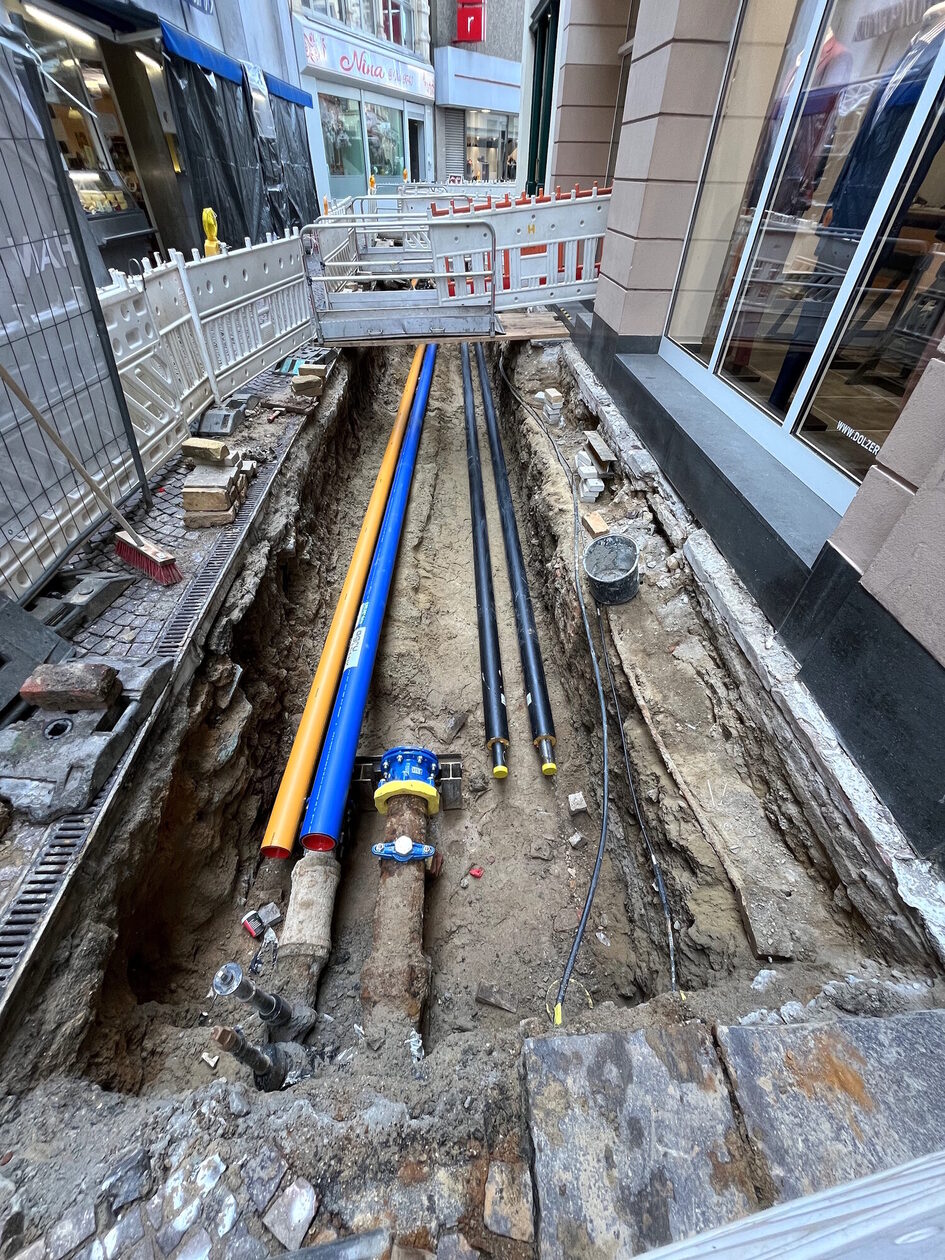 In einer Baugrube in der Ellenbogengasse sind Versorgungsleitungen zu sehen.