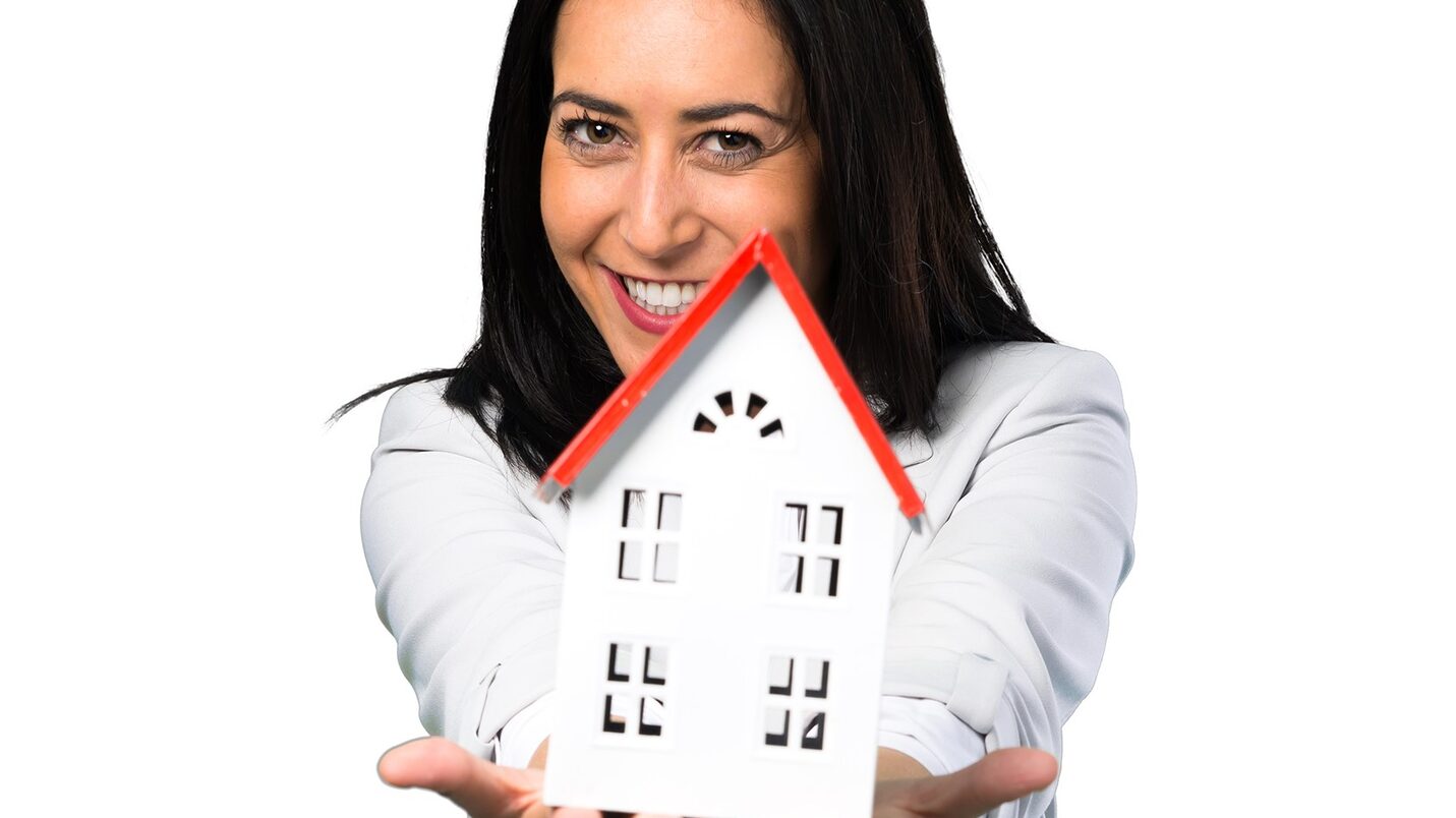 Pretty,Woman,Holding,A,Little,House,On,White,Background