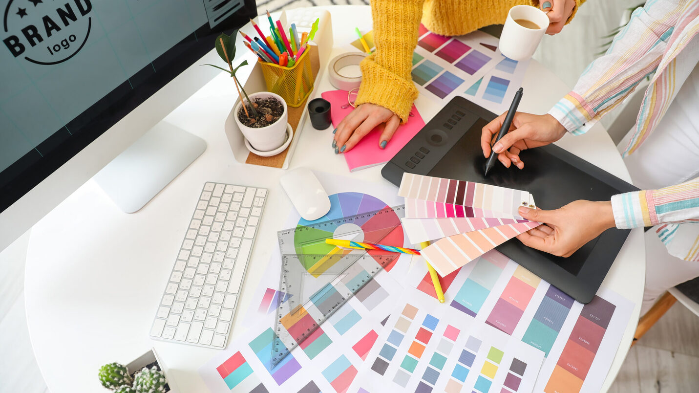 Graphic designer with colleague working in office