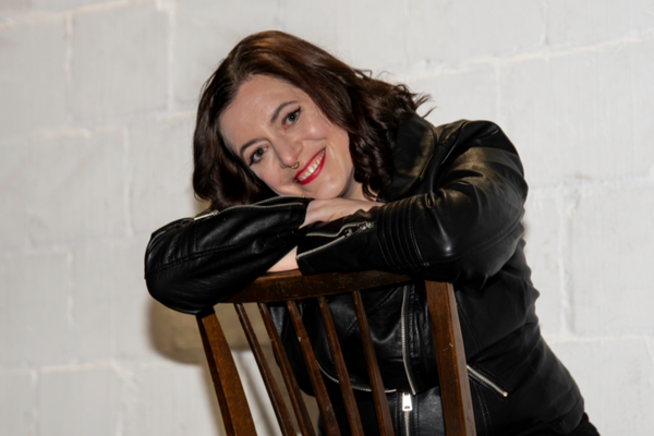 Femme brune assise sur une chaise, souriante